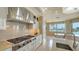 Gourmet kitchen offers stainless steel appliances, sleek white cabinetry, and scenic views at 464 Golden Gate Pt # 702, Sarasota, FL 34236