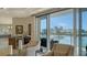 Cozy seating area with bar, offering beautiful views of the marina and city skyline from the adjacent balcony at 464 Golden Gate Pt # 702, Sarasota, FL 34236