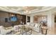 Elegant living room showcases custom built-ins, tray ceiling, and luxurious furnishings at 464 Golden Gate Pt # 702, Sarasota, FL 34236