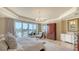 A bright main bedroom with a private balcony overlooking the city and the water at 464 Golden Gate Pt # 702, Sarasota, FL 34236