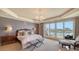 Spacious main bedroom boasts a tray ceiling, waterfront view, and access to a private balcony at 464 Golden Gate Pt # 702, Sarasota, FL 34236