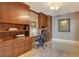 Spacious office featuring custom wood cabinets, a large desk, and neutral decor for a comfortable work space at 464 Golden Gate Pt # 702, Sarasota, FL 34236