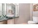 Modern powder room featuring a vessel sink on a dark countertop and contemporary fixtures and design at 464 Golden Gate Pt # 702, Sarasota, FL 34236