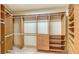 Spacious walk-in closet with adjustable shelving and drawers, providing ample storage at 464 Golden Gate Pt # 702, Sarasota, FL 34236