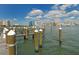 Harbor waterfront view of boat docks against a backdrop of the skyline on a sunny day at 464 Golden Gate Pt # 702, Sarasota, FL 34236