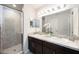 Contemporary bathroom featuring a glass walk-in shower and a double sink vanity at 4781 Vignette Way, Sarasota, FL 34240