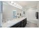 Bright bathroom featuring a double sink vanity with granite countertops and a shower-tub combo at 4781 Vignette Way, Sarasota, FL 34240