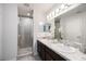 Bright bathroom features double sinks, granite countertops and a glass enclosed shower at 4781 Vignette Way, Sarasota, FL 34240