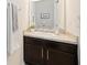 Cozy powder room featuring a vanity with dark cabinets and white countertops at 4781 Vignette Way, Sarasota, FL 34240