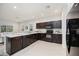 Kitchen with dark cabinets and stainless appliances, offering a modern cooking space at 4781 Vignette Way, Sarasota, FL 34240