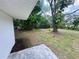 A view of the backyard with mature trees and a freshly laid patio at 4823 Linwood St, Sarasota, FL 34232