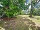 A spacious backyard featuring mature trees at 4823 Linwood St, Sarasota, FL 34232