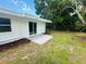 An exterior view of the backyard featuring a patio and lush greenery at 4823 Linwood St, Sarasota, FL 34232