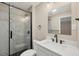 Bathroom features updated black fixtures, white vanity, and glass shower enclosure at 4823 Linwood St, Sarasota, FL 34232