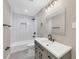 Updated bathroom features a modern vanity, tiled shower-tub, and black fixtures at 4823 Linwood St, Sarasota, FL 34232