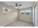 Bright bedroom with a ceiling fan, sleek wood floors, and two windows at 4823 Linwood St, Sarasota, FL 34232