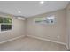 Bedroom featuring modern cooling unit, two windows, and wood flooring at 4823 Linwood St, Sarasota, FL 34232