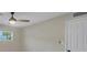 Bedroom featuring a ceiling fan, natural light, neutral color palette, and a door at 4823 Linwood St, Sarasota, FL 34232