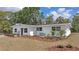 Charming single-story white home featuring a well-maintained lawn with mulch and updated landscaping at 4823 Linwood St, Sarasota, FL 34232