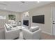 Bright living room with neutral furniture, large window, and a modern fireplace at 4823 Linwood St, Sarasota, FL 34232