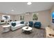 Staged living room featuring modern furniture, decor, natural light, and neutral color palette at 4823 Linwood St, Sarasota, FL 34232