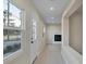 Bright hallway featuring smooth floors and a view into the living room with a fireplace at 4823 Linwood St, Sarasota, FL 34232