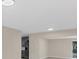 Bright open floor plan, view into the living room with a gray fridge in the kitchen at 4823 Linwood St, Sarasota, FL 34232
