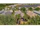 Aerial view of a tile roof home in a tropical neighborhood with lush landscaping and mature trees at 5009 Lake Overlook Ave, Bradenton, FL 34208