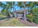Charming backyard with tropical foliage and comfortable screened in lanai at 5009 Lake Overlook Ave, Bradenton, FL 34208
