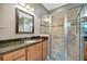 Bathroom with a glass shower, granite countertops, tiled floor, and a sink with vanity lighting at 5009 Lake Overlook Ave, Bradenton, FL 34208