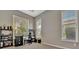 Bright room with neutral walls and carpet, large windows, and a ceiling fan at 5009 Lake Overlook Ave, Bradenton, FL 34208