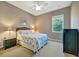 Bedroom features neutral walls, ceiling fan, natural light, carpet, and nautical-themed bedding at 5009 Lake Overlook Ave, Bradenton, FL 34208