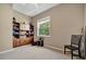 Bedroom with neutral color palette, ample light, carpet, built-in storage, and stylish black chair at 5009 Lake Overlook Ave, Bradenton, FL 34208