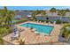 Community pool with many chairs, tables, umbrellas, and a clear view of the waterfront at 5009 Lake Overlook Ave, Bradenton, FL 34208