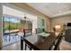 Cozy dining room featuring sliding glass doors to a screened patio with outdoor seating and tropical views at 5009 Lake Overlook Ave, Bradenton, FL 34208