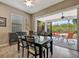 Dining area with a view to a screened patio and lush tropical landscape at 5009 Lake Overlook Ave, Bradenton, FL 34208