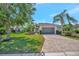 Well-manicured lawn and landscaping enhance this home's curb appeal; brick driveway leads to a two-car garage at 5009 Lake Overlook Ave, Bradenton, FL 34208
