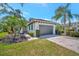 Well-manicured lawn and landscaping enhance this home's curb appeal; brick driveway leads to a two-car garage at 5009 Lake Overlook Ave, Bradenton, FL 34208