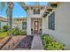 Inviting front entrance features a brick walkway, covered porch, and lush landscaping at 5009 Lake Overlook Ave, Bradenton, FL 34208