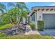 Charming front entrance with well-maintained landscaping, walkway, and front door at 5009 Lake Overlook Ave, Bradenton, FL 34208