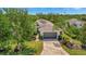 Attractive single Gathering home with a well manicured lawn, paved driveway, and lush, mature trees at 5009 Lake Overlook Ave, Bradenton, FL 34208