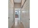Hallway with many doors, including entry to bathroom featuring granite countertop and glass shower at 5009 Lake Overlook Ave, Bradenton, FL 34208