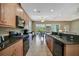 Kitchen with natural wood cabinets, stainless steel appliances, and breakfast bar at 5009 Lake Overlook Ave, Bradenton, FL 34208