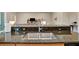 Updated kitchen sink and faucet with granite countertops and stainless steel sink at 5009 Lake Overlook Ave, Bradenton, FL 34208
