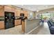 Well-lit kitchen with stainless steel appliances, wooden cabinets, and granite countertops at 5009 Lake Overlook Ave, Bradenton, FL 34208