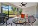Relaxing screened lanai with ceiling fan and outdoor dining set overlooking lush greenery at 5009 Lake Overlook Ave, Bradenton, FL 34208