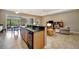 Open-concept living space connects kitchen to dining area and features tile flooring and natural light at 5009 Lake Overlook Ave, Bradenton, FL 34208
