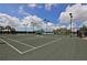 Immaculate community tennis court with a shelter for shade and convenient seating for breaks at 5009 Lake Overlook Ave, Bradenton, FL 34208