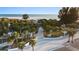 Scenic aerial view capturing the walkway, palm trees, and entrance to a stunning beachfront, creating a picturesque scene at 5134 Northridge Rd # 106, Sarasota, FL 34238