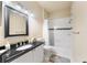 Bathroom featuring a single sink vanity with black countertops and a shower-tub combination with white tiling at 5134 Northridge Rd # 106, Sarasota, FL 34238